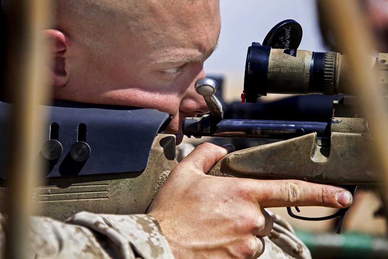 man with airsoft sniper rifle gun